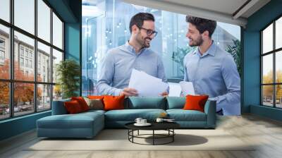 two handsome bearded business men discussing paperwork in office Wall mural