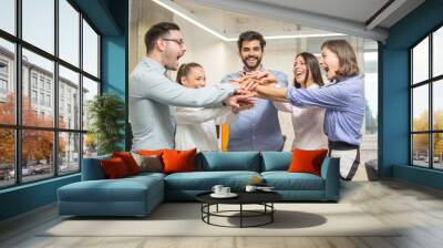 United business coworkers standing with hands together in office Wall mural