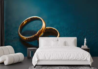 Wedding gold rings on blue background. Wall mural