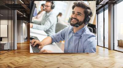 Young handsome technical support dispatcher working in call center. Wall mural