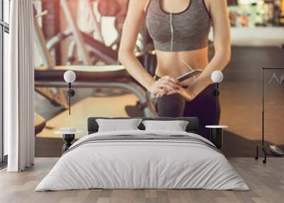 Young slim fit woman doing lunges in gym Wall mural