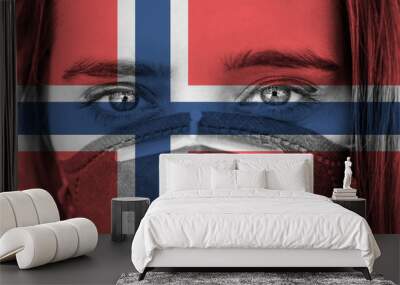 Closeup photo of woman's eyes wearing protective mask against the background of the Norway flag.  Wall mural