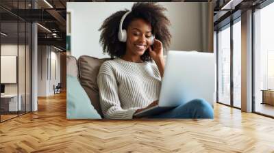 Happy Woman Using Laptop and Headphones at Home. Wall mural