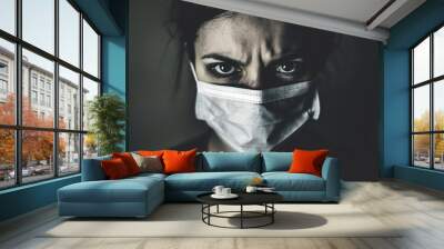 Woman in a Face Mask with an Intense Expression Wall mural