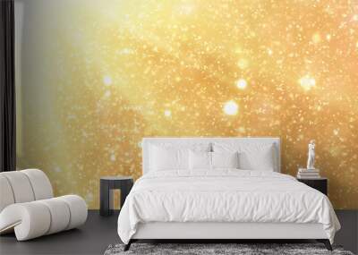 Golden rays and sparkles or glitter lights. Merry Christmas festive gold background.defocused circle bokeh or particles Wall mural