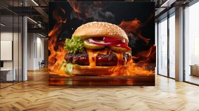 Delicious fastfood grilled hot fresh tasty cheeseburger, hamburger, burger with french fries and fire flames isolated on black background Wall mural