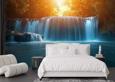 A beautiful waterfall in the forest with blue water and golden trees, sunlight shining through the leaves onto the sparkling river below, creating an enchanting scene of tranquility and beauty.  Wall mural