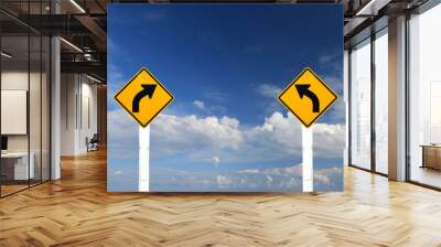 Left and  right turn warning sing on blue sky background Wall mural