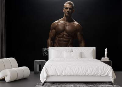 Fitness model man posing in studio Wall mural