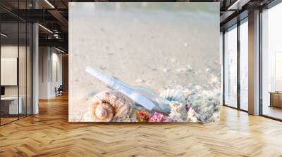 Bottle with a message or letter on the beach near seashell. SOS. Copy space. Wall mural