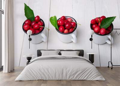 Cherry in enamel cup on white wooden background. Healthy, summer fruit. Cherries. Top view. Wall mural