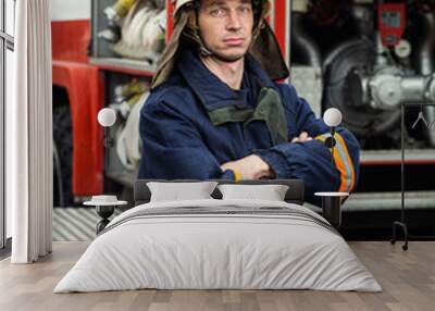 Fireman (firefighter) in action standing  near a firetruck. Emergency safety. Protection, rescue from danger. Wall mural