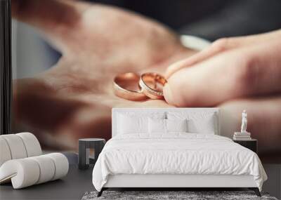 man holding wedding rings, groom getting ready in the morning before ceremony Wall mural