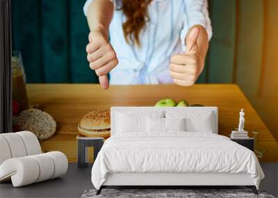 Woman is refusing to eat unhealthy hamburger. Cheap junk food vs healthy diet Wall mural