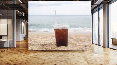 Cold coffee on beach with sea in background Wall mural