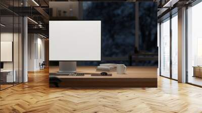 A computer mockup and decor on a wooden table in a modern dark office room at night. Wall mural