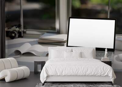 A modern office workspace tabletop against the window with notebook laptop mockup. Wall mural