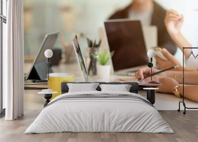 Businesspeople meeting on their project with digital device and office supplies on white desk Wall mural