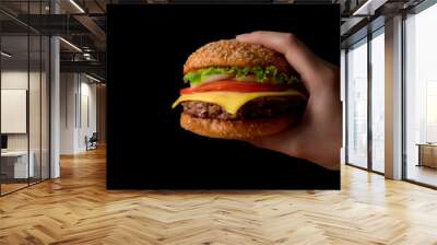 Close up view of a woman holding beef burger ready to eat Wall mural