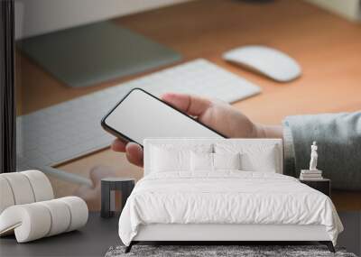 Close-up view of professional businessman looking at his blank screen smartphone Wall mural