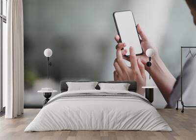 Close-up view of professional doctor using blank screen smartphone in her office room Wall mural