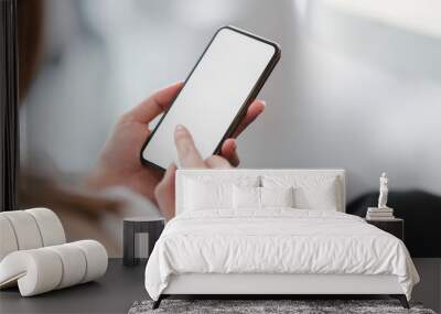 Cropped shot of businesswoman using smartphone in blurred office room Wall mural