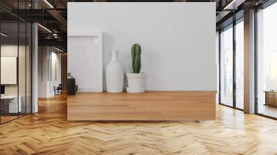 Cropped shot of comfortable office room with mock up frame, decorations and copy space on wooden table and white wall Wall mural