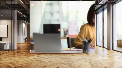 Cropped shot of female entrepreneur sitting in portable workspace Wall mural