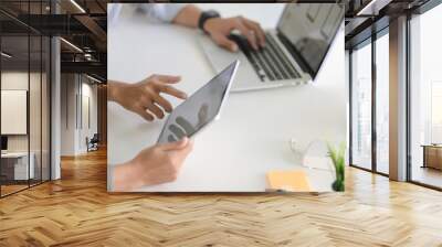 Cropped shot of UX web developer team working on his project with tablet and laptop computer Wall mural