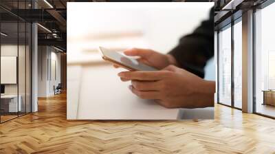 Cropped shot of young businesswoman working with blank smartphone Wall mural