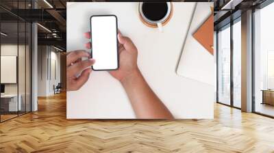 Cropped shot top view of businessman hands using smartphone mockup at the white office desk Wall mural