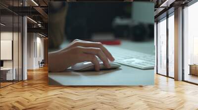 Female worker working with computer device on white office desk with camera and other supplies Wall mural