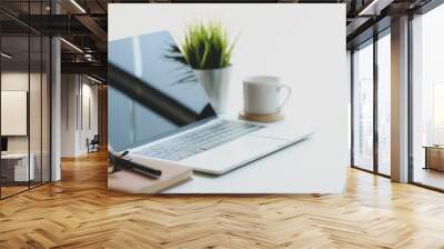 Open laptop computer with coffee cup and office supplies in comfortable workplace Wall mural