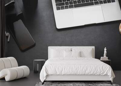 Overhead shot of dark modern workplace with laptop computer and office supplies Wall mural