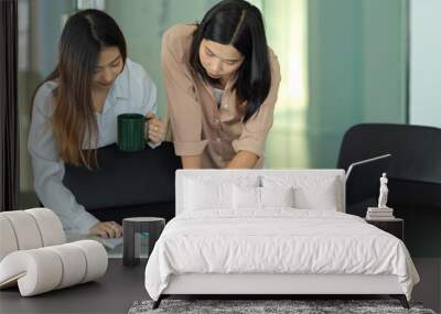 Portraits of two female office worker brainstorming on their work Wall mural