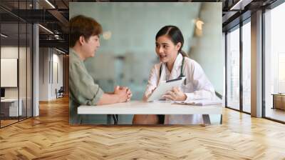 shot of a doctor showing a patient some information on a digital tablet Wall mural