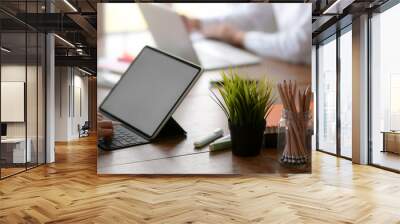 Side view of two young university students concentrating on their assignment on wooden desk Wall mural