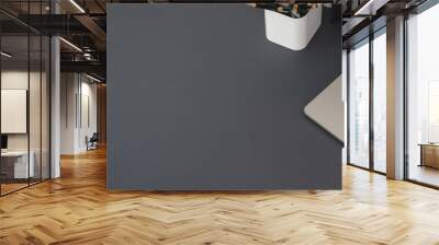 Top view of modern workplace with laptop computer and office supplies on dark grey table Wall mural