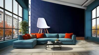 white chair in interior room with dark blue wall. Wall mural