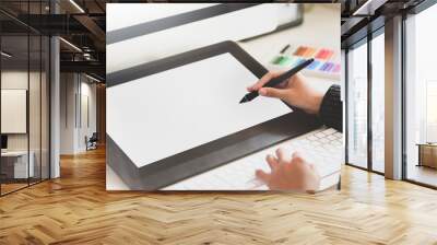 Young female graphic designer working with blank tablet in creative workplace Wall mural