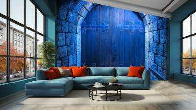 A weathered wooden door set in a stone archway, bathed in an eerie blue light. The door is heavy, with iron studs and hinges. It leads into a dark and mysterious hallway. Wall mural