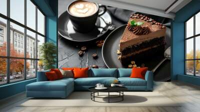 chocolate cream cake with nuts on a plate and a cup of cappuccino coffe on a black table Wall mural