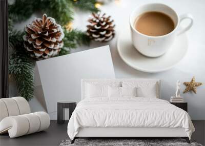 Christmas holiday card, coffee cup, pinecones, evergreen branches, and decorations on a white table, festive concept Wall mural