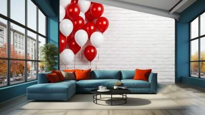 Group of red and white inflatable balloons on white brick wall background with copyspace. Interior of room for children or wedding party indoor. Wall mural