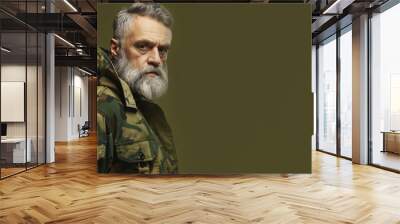 Portrait of mature man in camo jacket with intense expression, isolated against plain background, outdoor fashion concept Wall mural