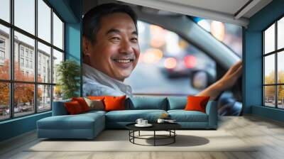 Smiling driver in city traffic at night, happy man steering car in urban lights, transportation concept Wall mural