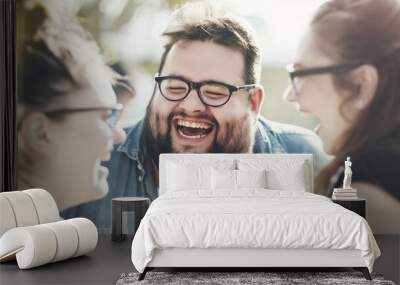 Three friends enjoying a fun day together, a bearded man laughing with two female friends in a joyful moment of shared happiness and camaraderie Wall mural