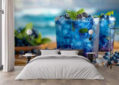 Three glasses of blueberry juice with ice cubes and mint leaves Wall mural