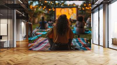 Generate an image of a pride-themed outdoor movie night, with people sitting on blankets and lawn chairs, watching LGBTQ+ themed films. Wall mural