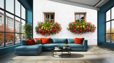 Two windows with flowers of traditional alpine house in Austria Wall mural